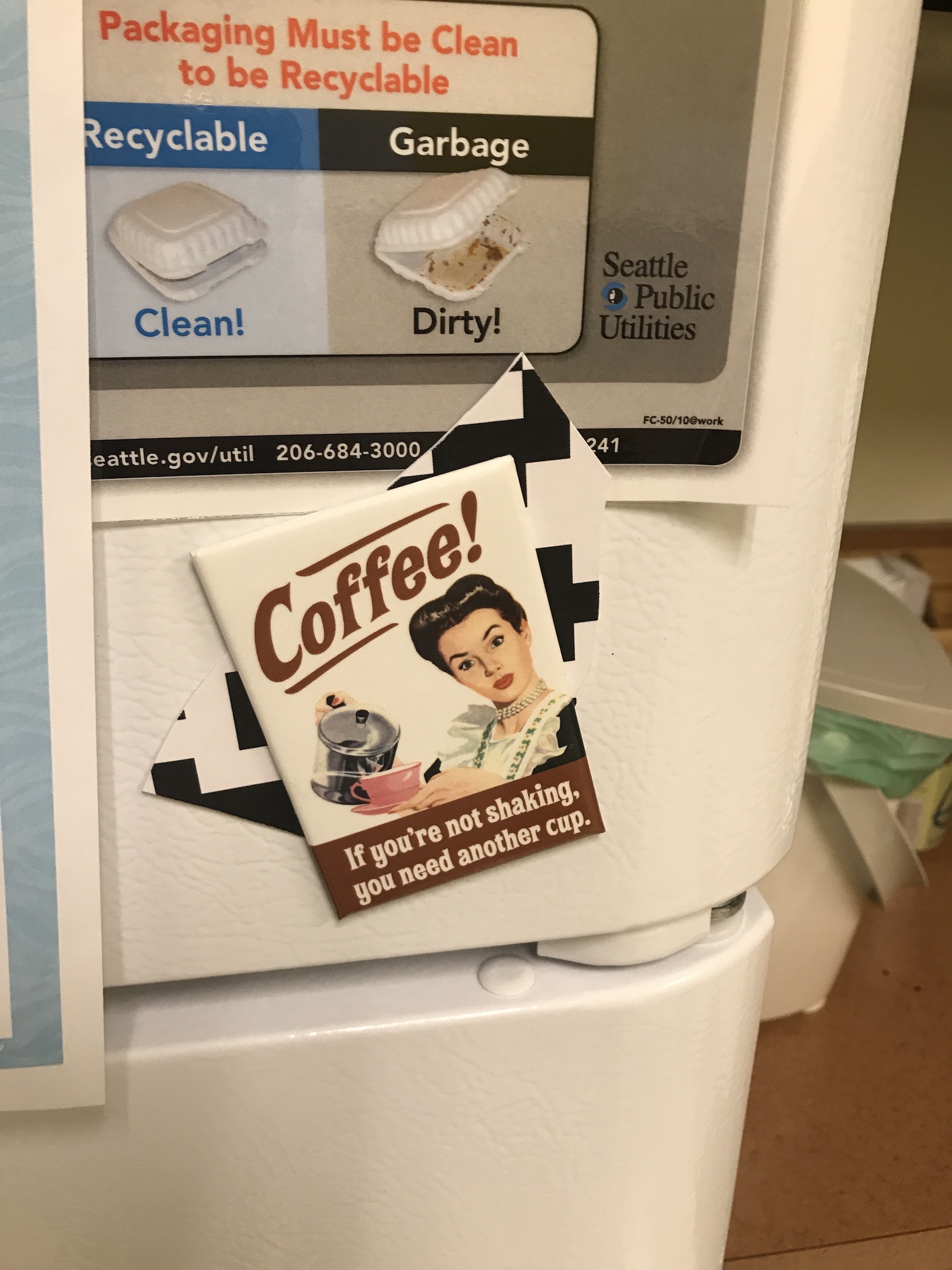 QR piece stuck to fridge with a coffee-themed magnet